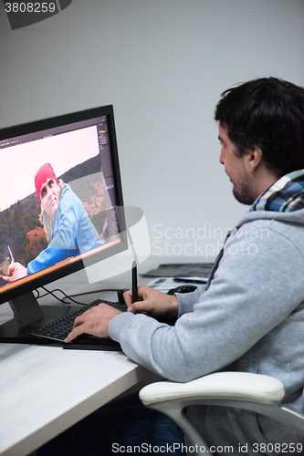 Image of photo editor at his desk