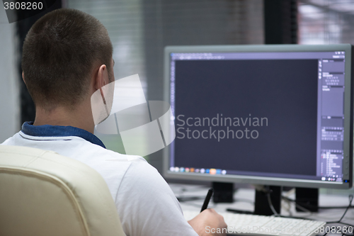 Image of photo editor at his desk