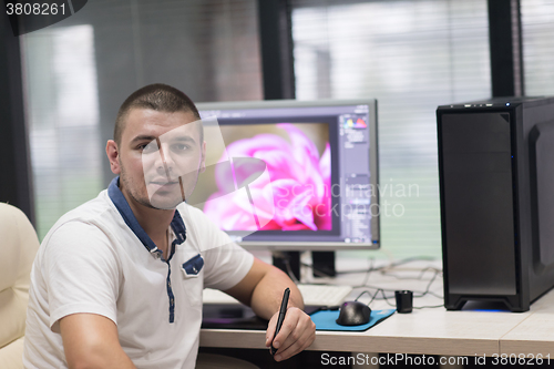 Image of photo editor at his desk