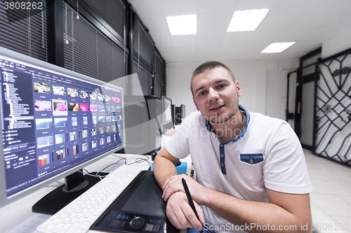 Image of photo editor at his desk