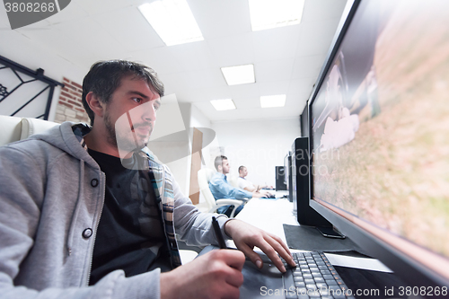 Image of photo editor at his desk