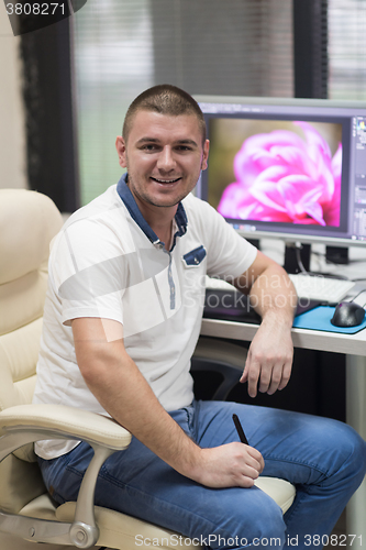 Image of photo editor at his desk