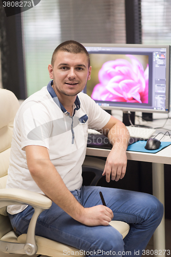 Image of photo editor at his desk