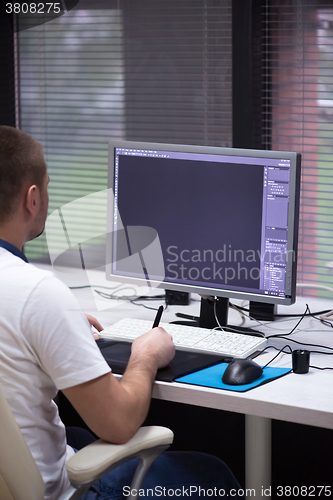 Image of photo editor at his desk