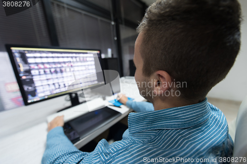 Image of photo editor at his desk