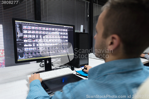 Image of photo editor at his desk