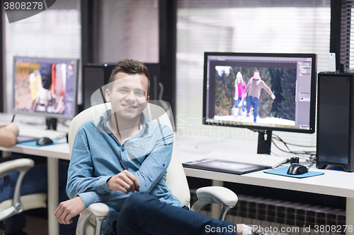 Image of photo editor at his desk