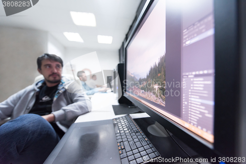 Image of photo editor at his desk