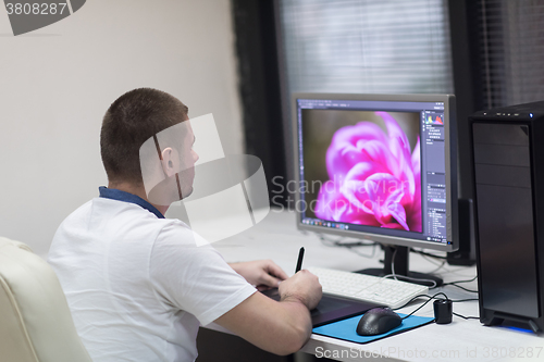 Image of photo editor at his desk