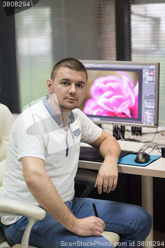 Image of photo editor at his desk