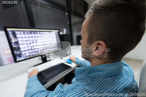 Image of photo editor at his desk