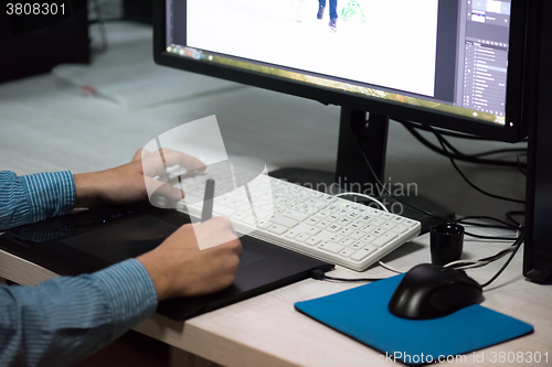 Image of photo editor at his desk