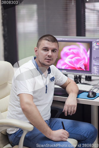 Image of photo editor at his desk