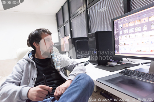 Image of photo editor at his desk