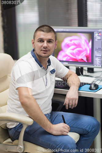 Image of photo editor at his desk