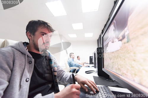 Image of photo editor at his desk