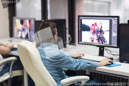 Image of photo editor at his desk