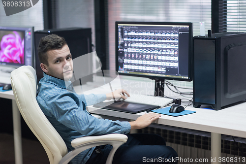 Image of photo editor at his desk