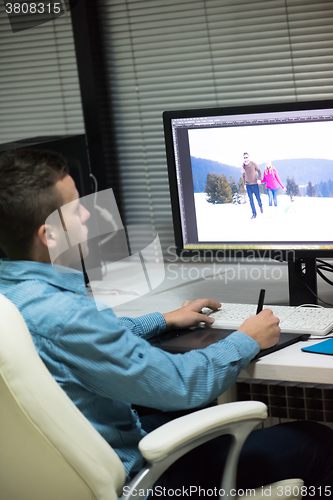 Image of photo editor at his desk