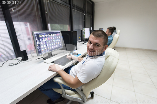 Image of photo editor at his desk