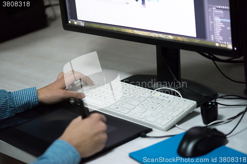 Image of photo editor at his desk