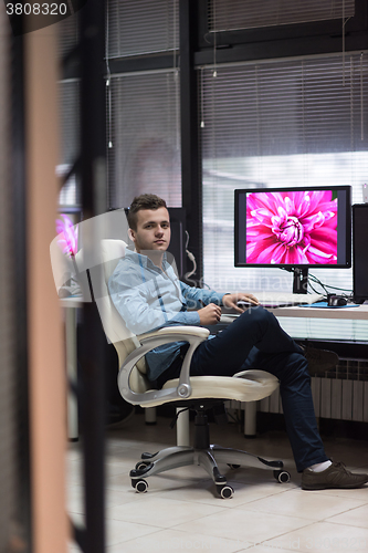 Image of photo editor at his desk