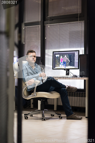 Image of photo editor at his desk
