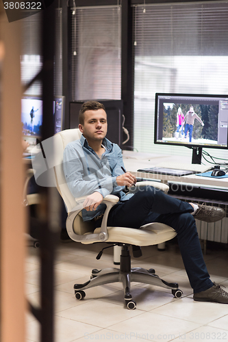 Image of photo editor at his desk