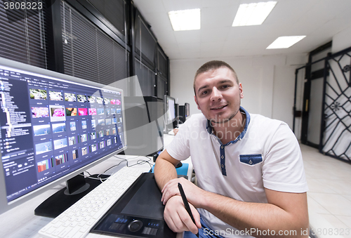 Image of photo editor at his desk