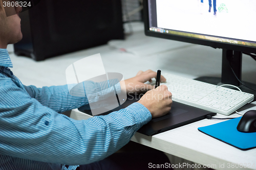 Image of photo editor at his desk