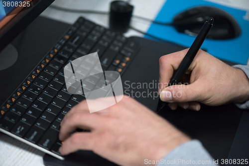 Image of photo editor at his desk