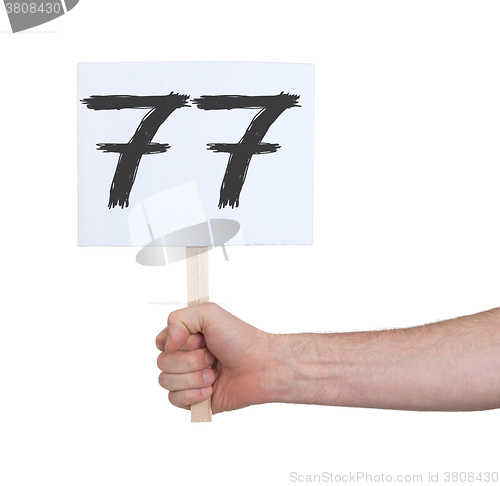 Image of Sign with a number, 77