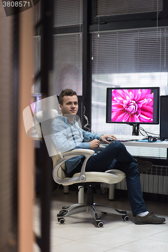 Image of photo editor at his desk