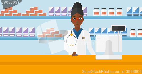 Image of Pharmacist at counter with computer monitor.