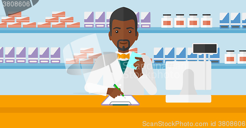 Image of Pharmacist taking notes.