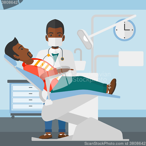 Image of Dentist and man in dentist chair.