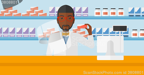 Image of Pharmacist showing some medicine.