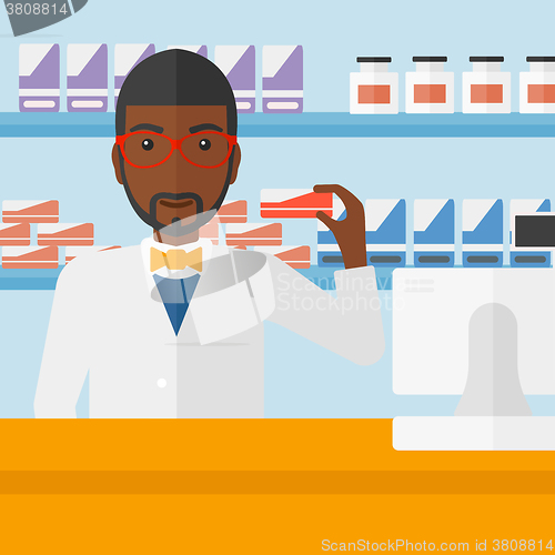 Image of Pharmacist showing some medicine.