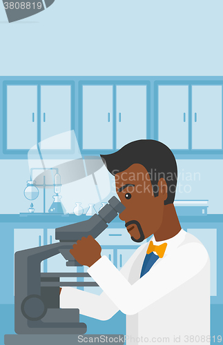 Image of Laboratory assistant with microscope.