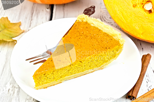 Image of Pie pumpkin in plate with cinnamon on board