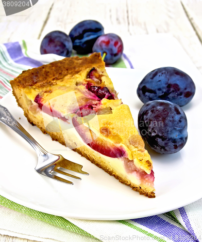 Image of Pie plum with sour cream in plate on board