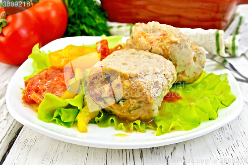 Image of Cutlets of turkey with vegetables in plate on board