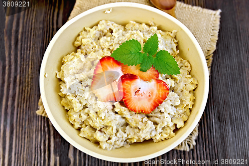 Image of Oatmeal with strawberries on sacking top