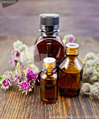 Image of Oil with burdock in bottled on board