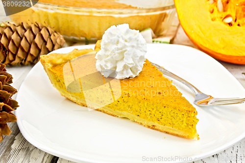 Image of Pie pumpkin in plate with cream on light board