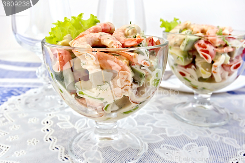 Image of Salad with shrimp and tomatoes in glass on napkin