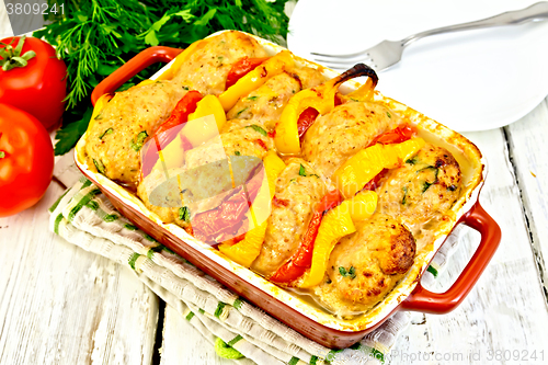 Image of Cutlets of turkey with tomatoes in pan on napkin