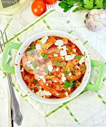 Image of Shrimp and tomatoes with feta in pan on napkin top