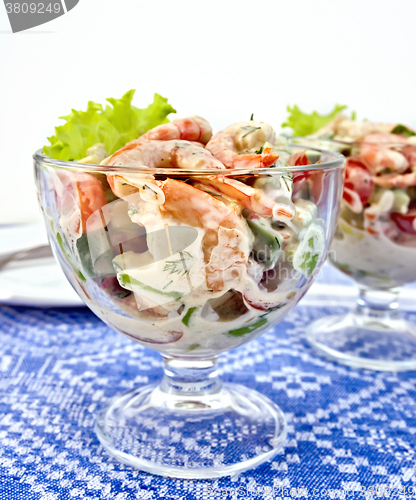 Image of Salad with shrimp and tomatoes in glass on tablecloth