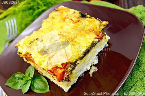 Image of Pie potato with tomato and spinach on board